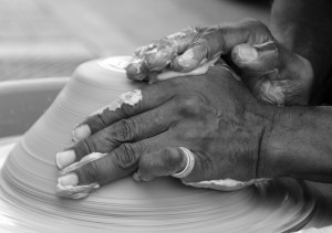 Hands creating pottery
